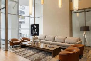 a living room with a couch and a table and chairs at AC Hotel by Marriott Panama City in Panama City
