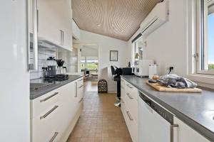 a kitchen with white cabinets and a counter top at FY421-Frorup-Grantoften-3 in Frørup