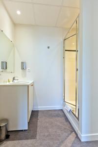 a bathroom with a sink and a window at Logis - Hôtel Restaurant Bellevue Annecy in Annecy