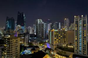a view of a city at night with buildings at AC Hotel by Marriott Panama City in Panama City +40 photos