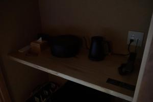 a shelf in a room with two black objects on it at Shiroyamakan in Shirakawa