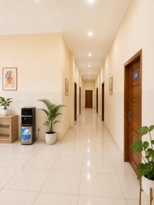 an empty hallway with plants in a building at Solota Boutique Hotel Syariah in Bonorejo +1 photo