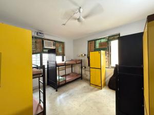 a room with yellow and black cabinets and a table at The Desire Delhi in New Delhi
