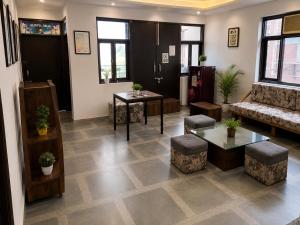 a lobby with a living room with a couch and tables at The Desire Delhi in New Delhi