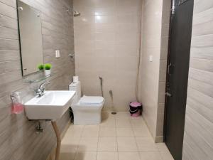 a bathroom with a sink and a toilet and a mirror at The Desire Delhi in New Delhi