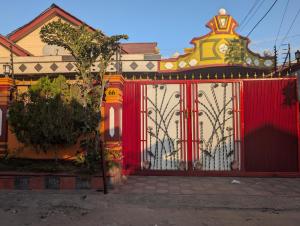 a red gate in front of a house at New Africa one inn in Dar es Salaam