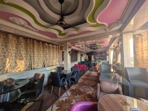 a restaurant with tables and chairs and a ceiling at New Africa one inn in Dar es Salaam