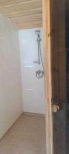 a shower in a bathroom with a glass door at Luigeranna B&B in Küdema +18 photos