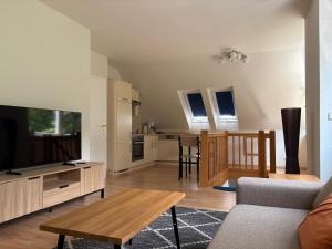 a living room with a couch and a table at Ferienwohnung Hagge Quickborn bei Hamburg in Quickborn +13 photos