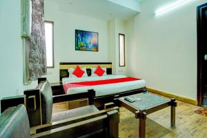 a bedroom with a bed and a table in it at Super Hotel O Sunshin Deluxe in Nagpur