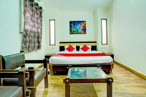 a hotel room with a bed and a couch at Super Hotel O Sunshin Deluxe in Nagpur