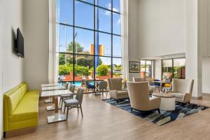 a lobby with tables and chairs and a pool at Comfort Inn Douglasville - Atlanta West in Douglasville