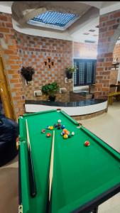 a green pool table with balls on top of it at Escape Inn in Trivandrum