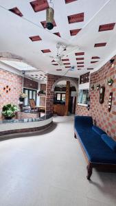 a living room with a couch and a brick wall at Escape Inn in Trivandrum