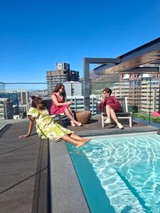a group of children sitting on the roof of a building at Urban Elephant 16 On Bree in Cape Town