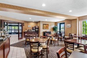 a dining room with tables and chairs in a restaurant at Sleep Inn & Suites Bay View Acme - Traverse City in Traverse City