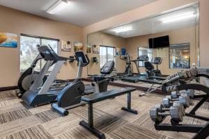a gym with treadmills and cardio equipment in a room at Comfort Inn & Suites Clinton - Jackson West in Clinton