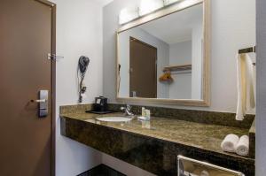 a bathroom with a sink and a mirror at Quality Inn & Suites Silverdale Bangor-Keyport in Silverdale +40 photos