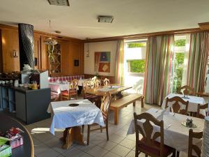 a restaurant with tables and chairs in a room at Hotel Lachnerhof in Erlangen