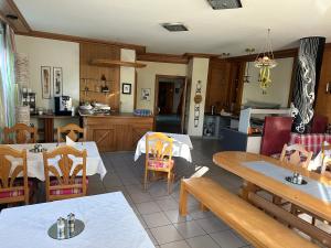 a kitchen and dining room with tables and chairs at Hotel Lachnerhof in Erlangen +16 photos