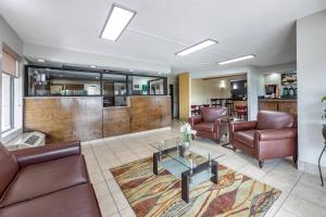 a living room with couches and a table in a room at Quality Inn Glasgow in Glasgow