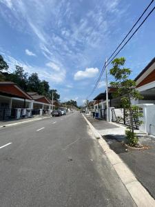 an empty street in a town with a wind turbine at Seroja Homestay Gopeng in Gopeng