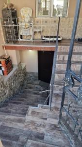a set of stairs in a room with a fireplace at Къща Теяна in Tryavna