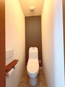 a bathroom with a white toilet in a room at Hitori Otaru in Otaru