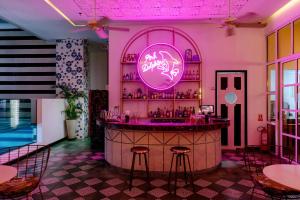 a bar in a restaurant with pink lighting at Faranda Collection Barranquilla, a member of Radisson Individuals in Barranquilla +96 photos