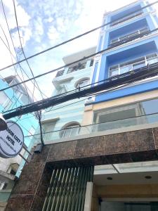 a blue building with a sign in front of it at SG Cozy2 Hotel - Pham Ngu Lao Street in Ho Chi Minh City