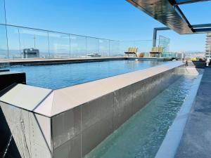 a swimming pool on the top of a building at Urban Elephant 16 On Bree in Cape Town