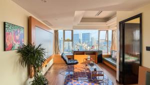 a living room with a view of a city at INVIS Urban High-rise Suites in Chengdu