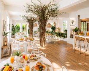 a dining room with a table with food on it at Cocoon Signature in Flic-en-Flac
