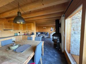 a kitchen and dining room with a large wooden table at Chalet La Renarde in Villars-sur-Ollon