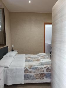 a bedroom with a bed and a door to a room at Cumpa Luca Bed and breakfast in Scalea