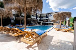 a swimming pool with lounge chairs and a resort at Blue Border in Vama Veche