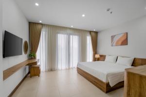 a hotel room with a bed and a television at Gao House in Hanoi