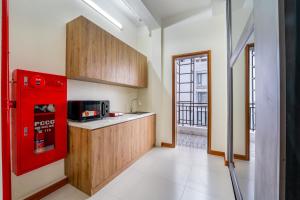 a kitchen with a red appliance in a room at Gao House in Hanoi