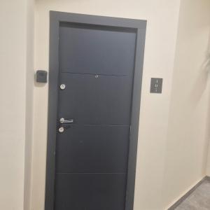 a black door in the corner of a room at Dana Residence in Floreşti +4 photos