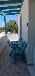a blue picnic table sitting on a porch at Alegrias spot in Adamantas