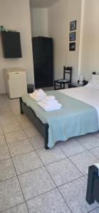 a hotel room with a bed with towels on it at Alegrias spot in Adamantas