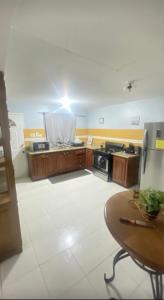 a kitchen with a stove and a table in it at Villa lux in Portmore