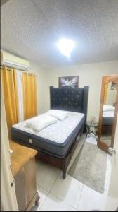 a small bedroom with a bed in a room at Villa lux in Portmore