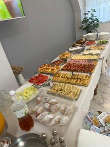 a buffet line with many different types of food at Hotel Alga Velipoje in Velipojë