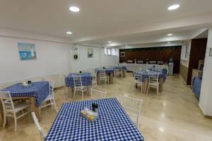 a dining room with blue and white tables and chairs at Blue Border in Vama Veche