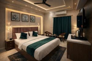 a hotel room with a bed and a television at Royal Awadh Inn Near Shree Ram mandir in Ayodhya