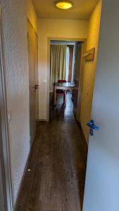 an empty hallway with a table in a room at Résidence Serre-Ponçon in Chorges