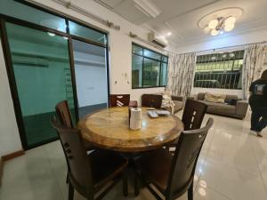 a dining room with a wooden table and chairs at Stay181 Bintulu in Bintulu