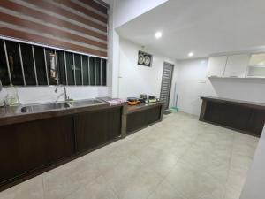 a large kitchen with a sink and a counter at Stay181 Bintulu in Bintulu