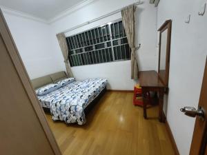 a bedroom with a bed and a window and a desk at Stay181 Bintulu in Bintulu